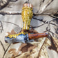 Double reed duck call made from stabilized and dyed amboyna burl wood with cocobolo wood tone board