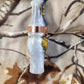 Double reed duck call made from stabilized and dyed amboyna burl wood with cocobolo wood tone board
