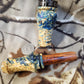 Double reed duck call made from stabilized and dyed yellow cedar burl wood and cocobolo tone board